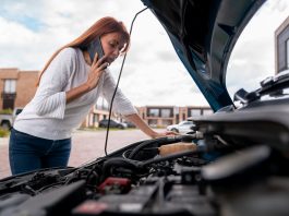 A woman is calling the mechanic after her car broke down.