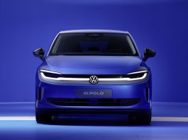 Front view of a blue Volkswagen ID. POLO facing the camera, in a blue studio setting with headlights on and VW emblem visible on the grille.
