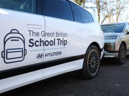 White car with branding reading 'The Great British School Trip' and a Hyundai logo, parked beside another vehicle.
