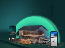 BMW and SOLARWATT Expand Joint Partnership Modern house with solar panels on the roof, a glowing green energy arc, and smartphones displaying a home energy app.