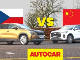 Two SUVs face off in a car comparison, with the Czech flag on the left, the China flag on the right, and a bold VS between them, Autocar branding below.