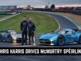 Two drivers in racing suits pose on a race track beside two McMurtry Speirling race cars, under a bold banner.